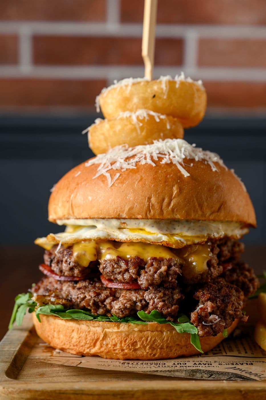 Spiros Royale burger stacked with onion rings