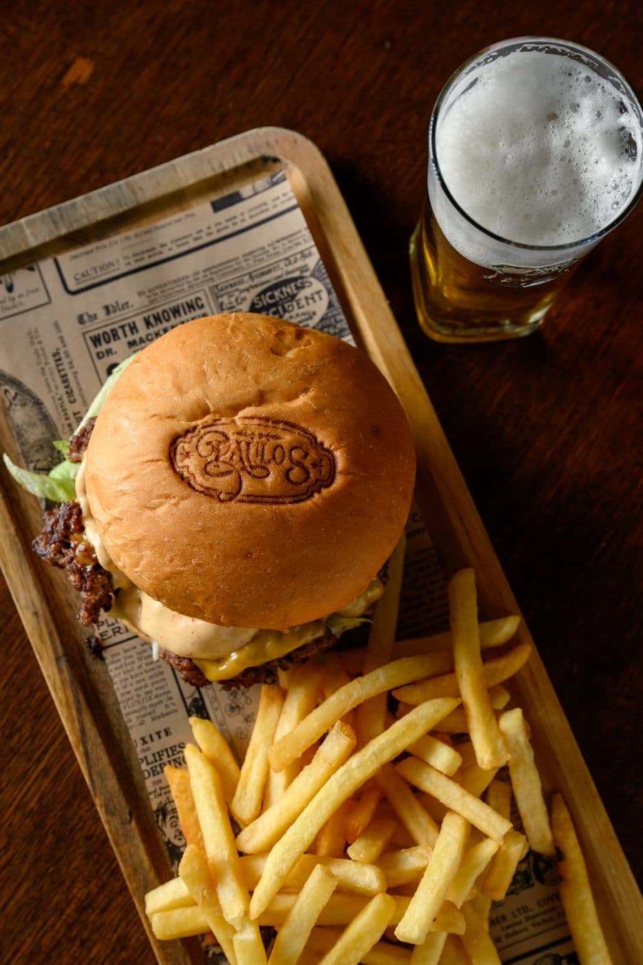 New Haven burger and fries seen from above, with a beer