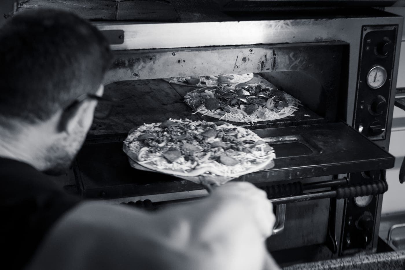 Pizzas baking inside the stone oven